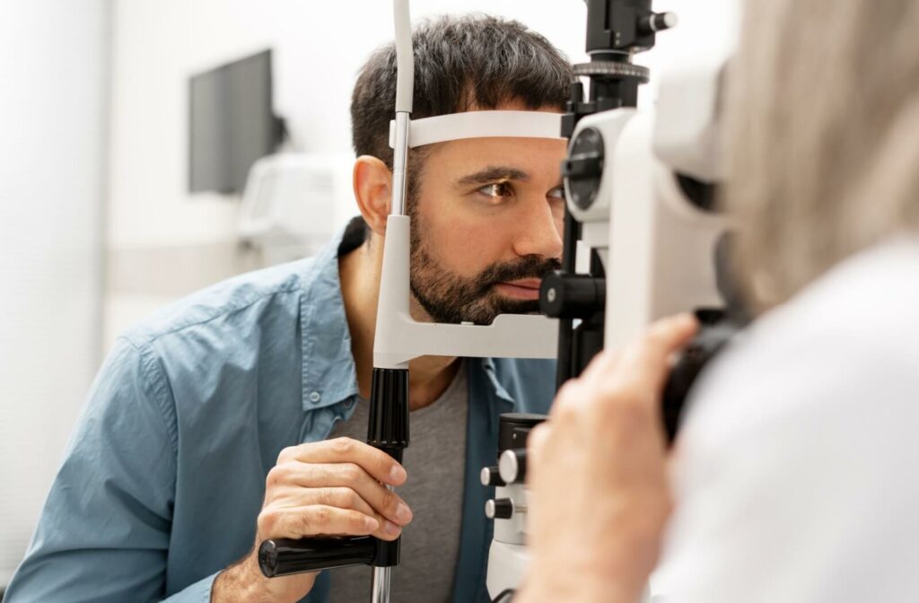 A close-up of an adult undergoing a comprehensive eye exam in a bright clinical setting