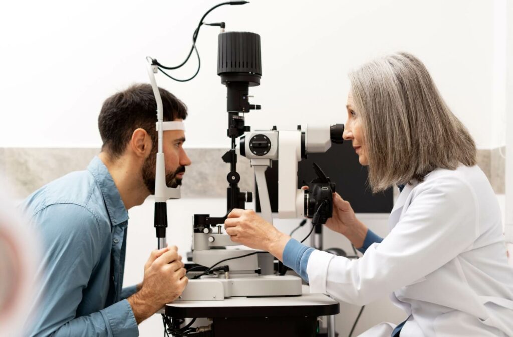 Optometrist performing an eye exam using a phoroptor on a patient in a bright setting