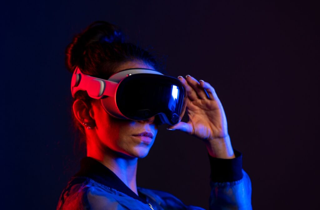 Close up of a woman adjusting her virtual reality headset.